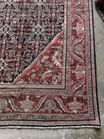 Mahal rug corner showing detailed charcoal grid and floral design