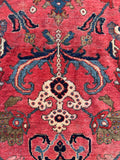 Historic hand-knotted Persian floor covering with a timeless botanical pattern and character-rich wear.