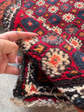 Cushiony soft wool Baluchi accent rug close-up photograph emphasizing the plush pile structure and luxurious hand-knotted texture.