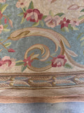 Pastel Aubusson tapestry with swirling woven texture and elegant French floral design.