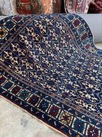 Starburst border detail on Caucasian rug.