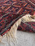 Vegetable dyed wool Baluchi rug detailed view highlighting hand-knotted wool pile and authentic 1900s craftsmanship.