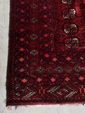 Corner detail showing layered border bands and geometric motifs.