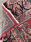 Underside view of authentic 100-year-old Persian floor covering featuring intricate floral details and exceptional durability.