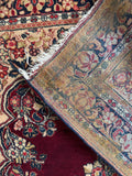 Underside view of antique Persian rug showing texture and weave with old glue stabilization applied to the back edges for added durability and edge-wear protection.
