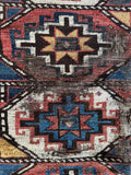 Distressed antique Kazak rug with traditional Caucasus tribal motifs and faded vegetable dyed wool.
