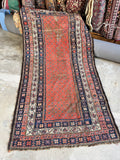 Antique Persian rug handwoven with vegetable-dyed wool featuring a teal green lattice on terracotta field.