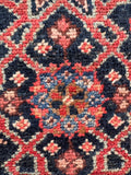 Close up of affordable antique Persian area rug overhead perspective showing washed, clean condition and balanced proportions.