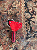 1930s hand woven Persian rug showing contrast between the red of the tape and the terracotta color in the rug