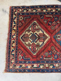 Coral, aqua, cantaloupe, and pink accents in the rug’s medallions.