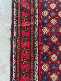 Durable high traffic Baluchi entry rug demonstrating the thick wool pile, sturdy foundation, and border band design.