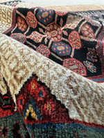 Long Persian rug with detailed medallion and camel hair border.