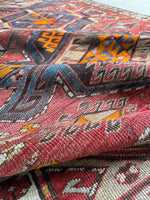 Up close view of weave, aged dyes, and  low pile.