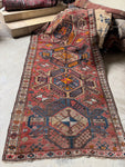 Full view of large antique eagle Kazak rug showing overall design and color palette.