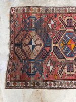 View of one end of the rug featuring aged dyes.