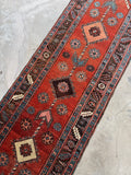 Close-up of antique Caucasian rug showing healthy wool pile and handmade texture.