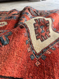 Close up of vegetable dyed wool and tribal pattern of antique 1900s Caucasian runner.
