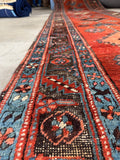Rustic antique Caucasian runner with bold geometric pattern and durable wool construction.