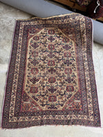 Antique Afshar Persian rug with geometric floral medallions on an earthy field.