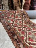 Antique Persian Bakhtiari rug with a diamond trellis design on a warm ivory ground.
