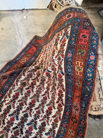 Natural dye wool rug with structured floral patterns.