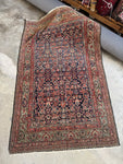 Antique Persian Mahal rug with navy Herati fish pattern.