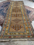 Hand knotted antique runner with wool foundation and soft abrash across the field.