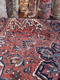 Edgy angular tribal Persian rug detail photo focusing on sharp geometric leaf sprays and traditional Heriz motifs.