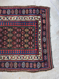 Handmade antique Persian rug with tribal motifs and vegetable dyed wool.