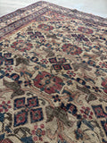 Early 1900s Afshar tribal rug showing faded plum and aubergine tones.