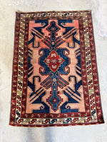 Antique Persian rug showing natural color variation and bold design.