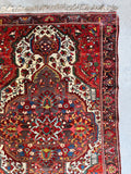Hand knotted wool rug featuring sky blue center point and ivory floral accents.
