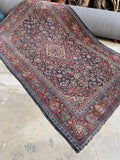 1920s antique Persian Tabriz rug with red ground and navy medallion, size 4x7.