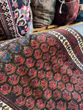Vintage Persian runner with chocolate brown field and colorful boteh chain.