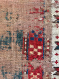 Vintage green tribal accent rug with time-earned antique wear and multi-border design.