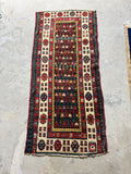 Worn antique Caucasian hallway runner in red, deep blue, ivory and golden yellow.