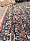 Antique Persian Rug 8x11 handmade wool area rug with coral pink colors and traditional floral design.