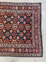 One end of the rug showing main field and border bands