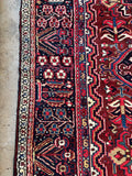 Antique Persian Heriz rug. Heavy hand knotted wool carpet with full pile, vibrant vegetable dyes, and timeless tribal character.