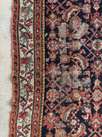 Persian rug with mint green in the main border and some scattered wear. 