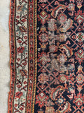 Persian rug with mint green in the main border and some scattered wear. 