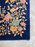 Dark navy blue Art Deco Chinese rug with floral design in the corners.
