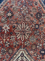 Close-up view of tribal Shiraz rug showing natural vegetable-dye palette.