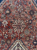Close-up view of tribal Shiraz rug showing natural vegetable-dye palette.