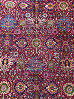 Close-up of intricate floral motifs on vintage Persian rug
