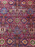 Close-up of intricate floral motifs on vintage Persian rug