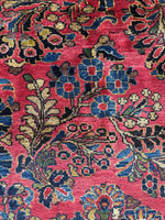 Close-up of floral spray pattern on antique rug