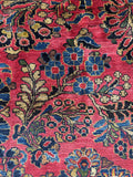 Close-up of floral spray pattern on antique rug