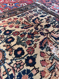Distressed antique Persian kitchen rug detail photo showcasing characterful vintage wear and authentic low pile texture.