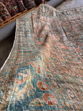 Antique Persian rug with softened colors from a traditional compound wash